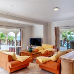 villa blossom living area orange couches